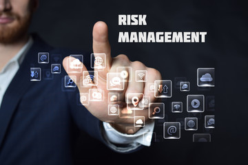 A businessman shows an inscription:RISK MANAGEMENT