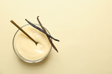Vanilla pudding and sticks on color background
