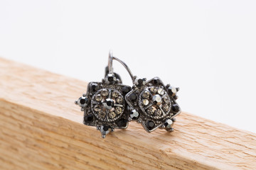 Pair of vintage earrings set on a wooden board