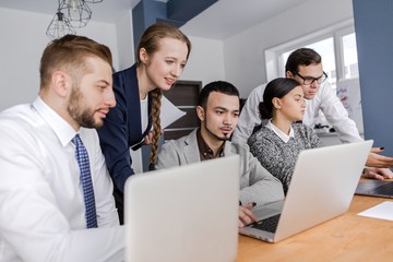 Business partners work in a team with laptops conducting brainstorming