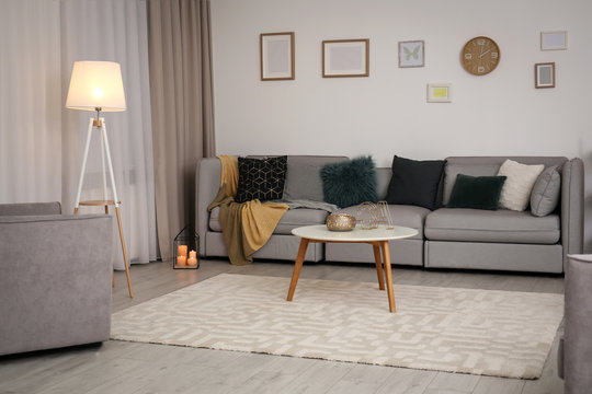 Modern living room interior with comfortable sofa and small table