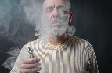 portrait of a man with beard who is vaping
