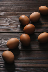 raw chiken eggs on wooden table