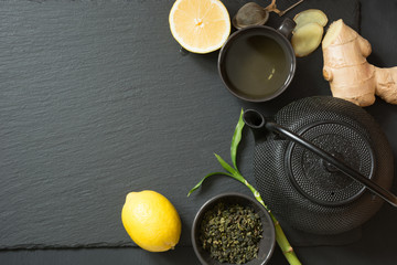 Green japanese tea on black stone table. Top view with copy space. Square image.