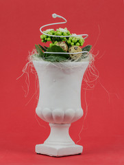 white vase on a red background