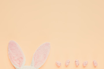 Easter holiday background with bunny ears and easter eggs in coffee cup