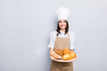 Industry prepare organic natural dough tasty fresh white clothes professional. Portrait of cheerful kind delightful baker demonstrating wooden tray with appetizing food isolated on gray background