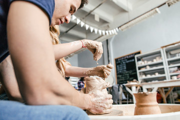 Obraz premium Family young couple make a pot using a pottery wheel in the Studio