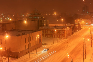 Snowfall in the city at night