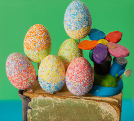 multicolor decorated easter eggs in vintage book on colorful background 