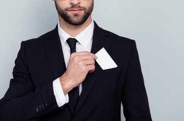 Close up photo of serious smart concentrated confident intelligent corporate executive boss chief employer employee putting card to the pocket of blazer isolated on gray background