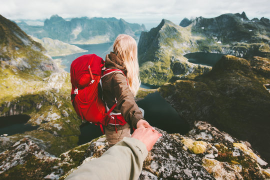 Couple travelers follow holding hands in  mountains Norway landscape love and Travel lifestyle concept family traveling active adventure hiking vacations