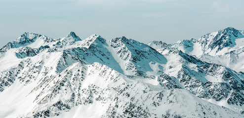 Winter landscape in the Soelden. High snow-capped mountains against the cloudy sky