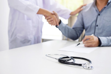 Doctor and patient shaking hands after treatment