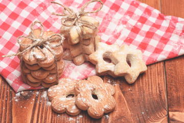 Tea cookies on wooden background. Star and flower shaped biscuits