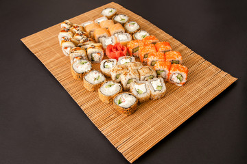 Set - sushi, rolls, sashimi on the mat