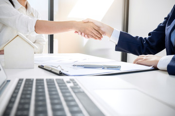 Handshake after good cooperation, Real estate broker residential agent shaking hands with customer after good deal agreement house rent listing contract