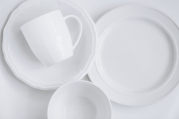 set white utensils three different plates cup plate white background