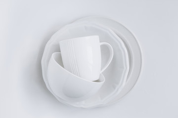 set white utensils stack three different plates cup white background isolated
