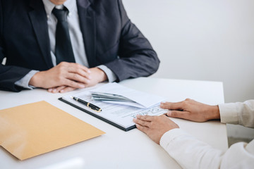 Bribery and corruption concept, bribe in the form of dollar bills, Businessman giving money in the envelope while making deal to agreement a real estate contract and financial corporate