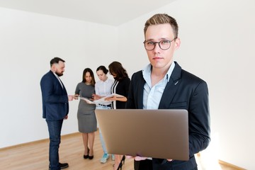 Designer with glasses working on a laptop project