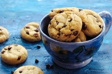 Homemade Chocolate chip cookies on dark blue background, overhead view
