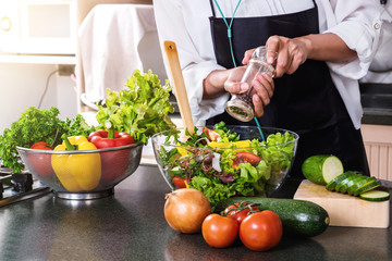 Young happiness Woman Cooking vegetables salad in the kitchen, Healthy food concept