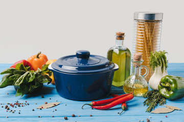 ingredients for cooking pasta with vegetables and pan on table