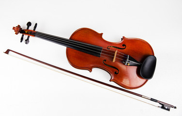 Closeup the classic violin put beside wooden bow on white background,show size and body of violin.
