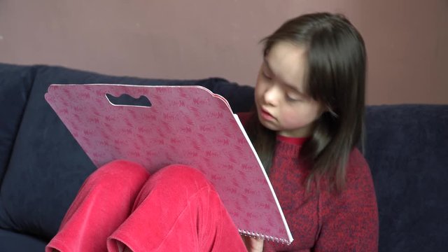 Down syndrome girl is drawing