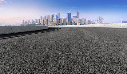 Obraz premium The empty asphalt road is along the modern commercial building in the Chinese city