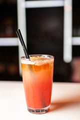 Colorful orange cocktail in bar