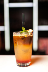 Orange cocktail with mint in bar