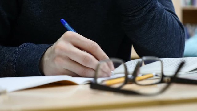 Man at business meting . Entrepreneur writes among his colleagues during a general meeting in business center.