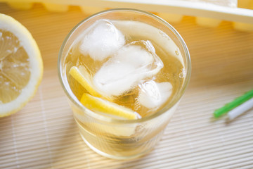 Green tea with ice and lemon in a glass