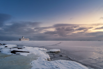 Scenic winter landscape with cruise and sunset at cold evening in Helsinki, Finland