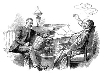 Zwei Männer unterhalten sich am  Schreibtisch