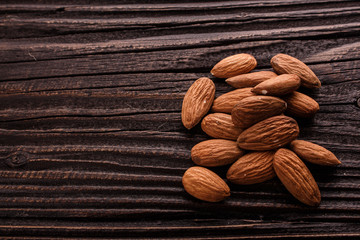 almond essential oil on a wooden background