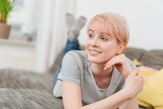 Relaxed smiling woman watching to the left