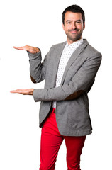 Handsome man holding something on isolated background