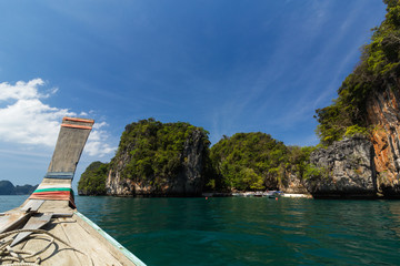 The tumbling boat in the clear blue sea on the blue sky of Krabi, Thailand.