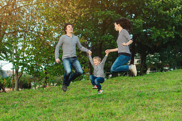 happy young family spending time together in park