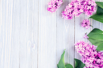 Lilac flowers on wooden table background