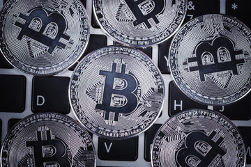 silver bitcoin on a laptop keyboard computer