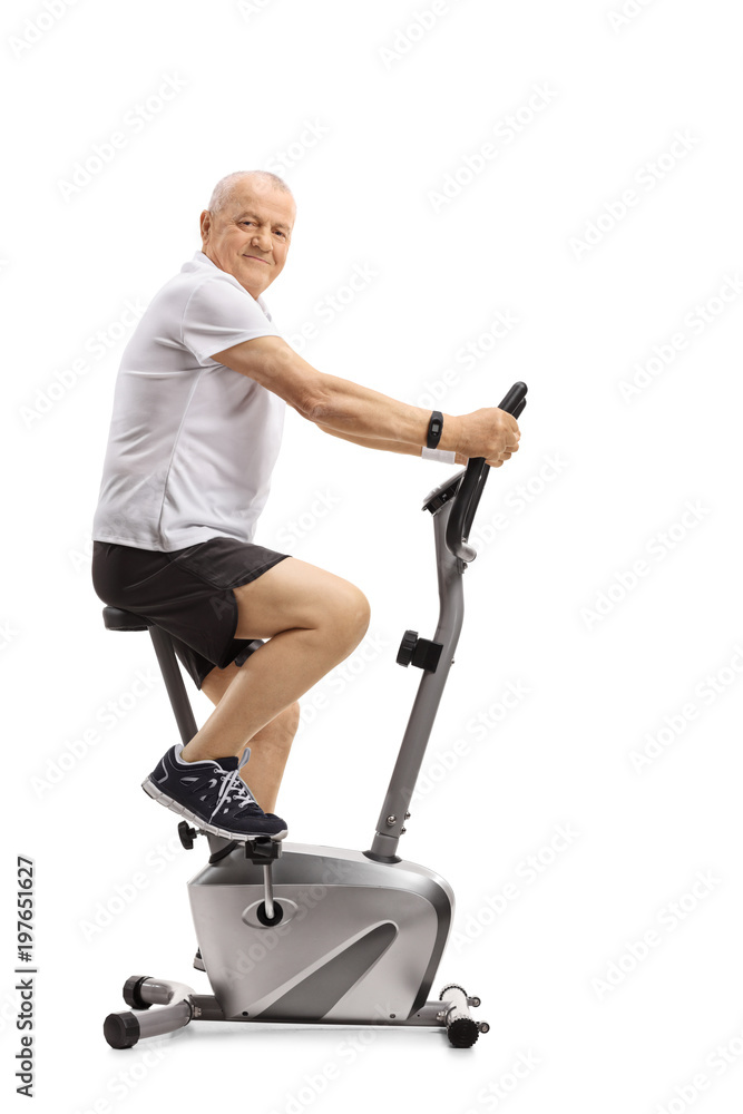 Poster mature man on a stationary bike looking at the camera