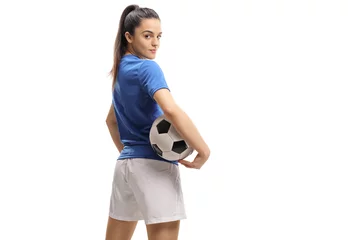Türaufkleber Female soccer player with a football looking over her shoulder © Ljupco Smokovski