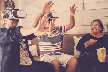 elderly senior couple playing ith goggles headset