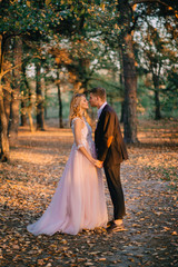 portrait of happy newlyweds during a walk in the forest