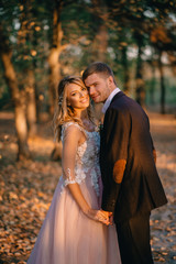 portrait of happy newlyweds during a walk in the forest