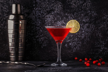 Glass of cosmopolitan cocktail decorated with lime
